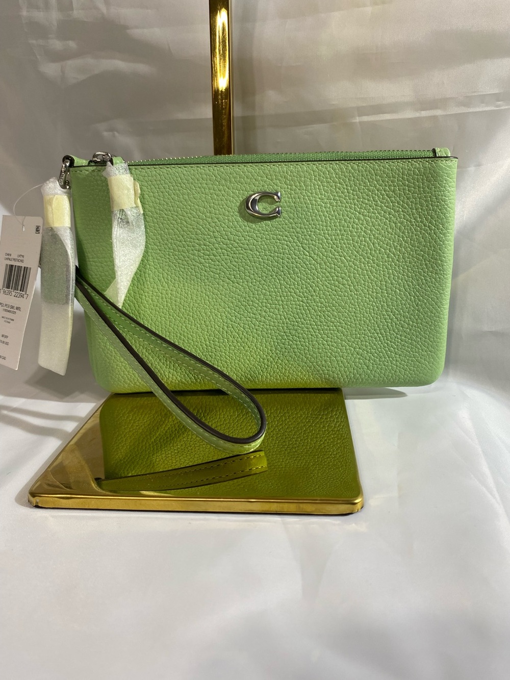 NWT Coach Small Polished Pebble Leather Wristlet in a pale pistachio